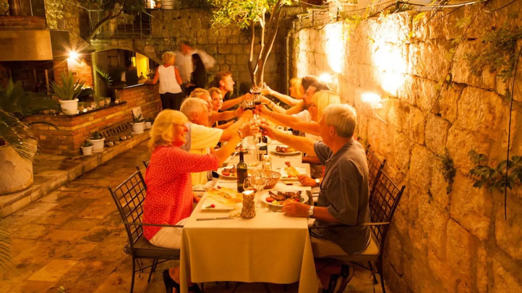 Group of people toast each other at a restaurant in Dubrovnik