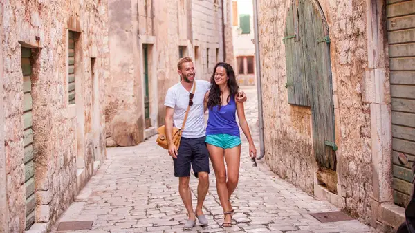 Couple walk the back streets of Trogir