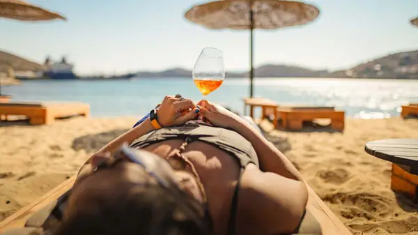 Woman lying on the beach in Schinoussa