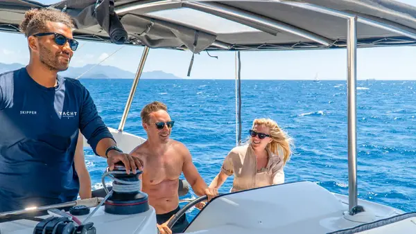 Skipper and guests sailing on a catamaran