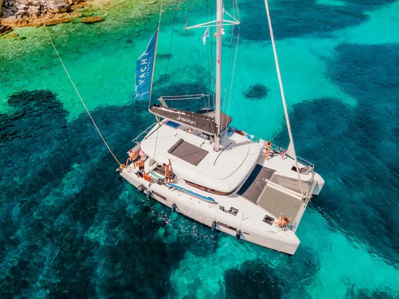 Luxury catamaran in a blue bay in Greece.