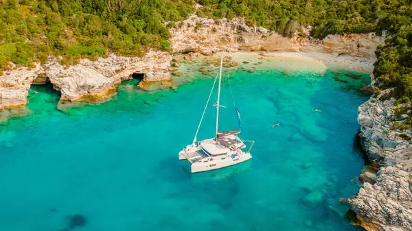 Catamaran anchored in a bay in Antipaxos