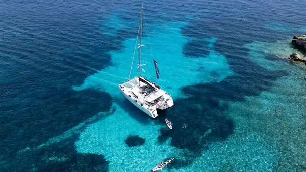 Catamaran in a blue bay in Greece