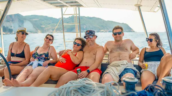 Friends pose for a photo on a catamaran