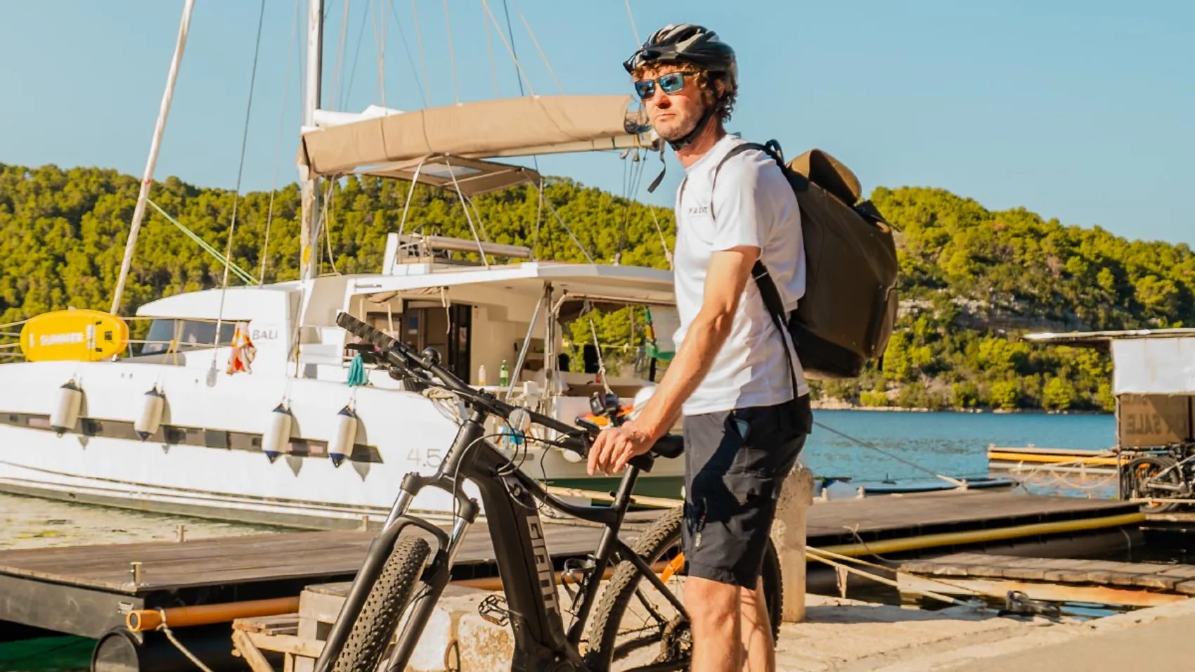 Croatian cycling guide standing with a bike 