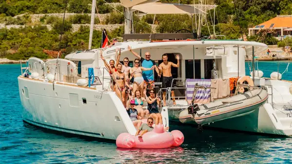 Group of people on the back of a catamaran 