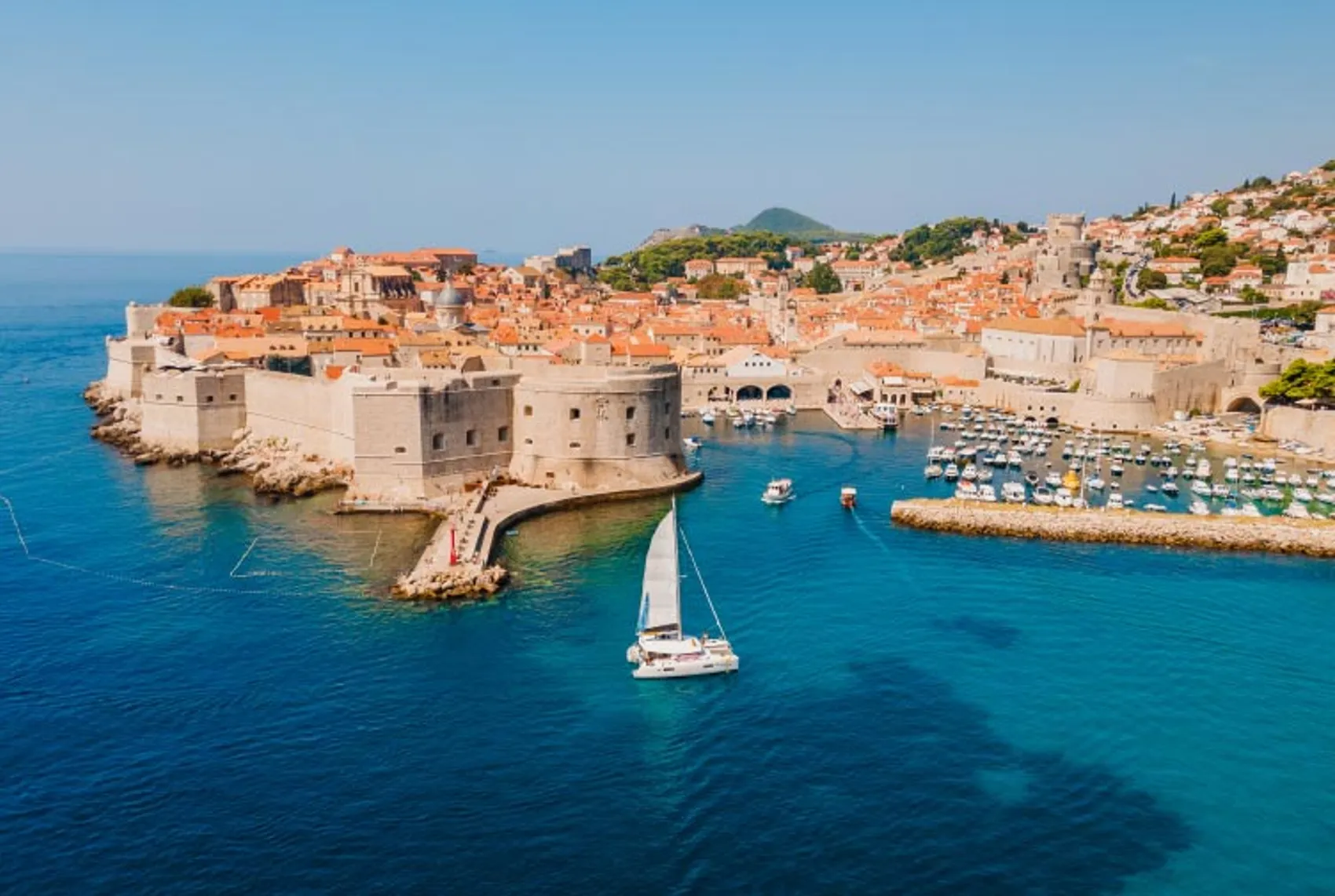 Yacht Getaways catamaran sailing next to the old town walls in Dubrovnik