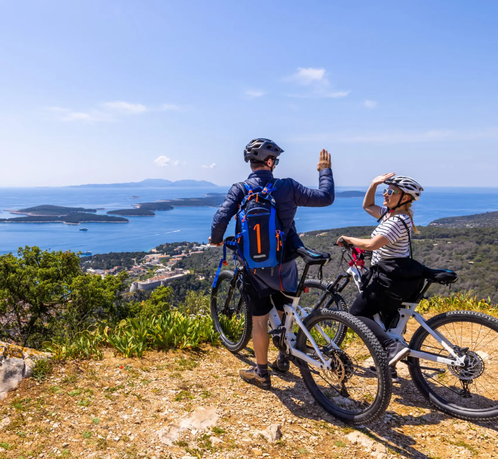 Couple on their bikes high five in Croatia