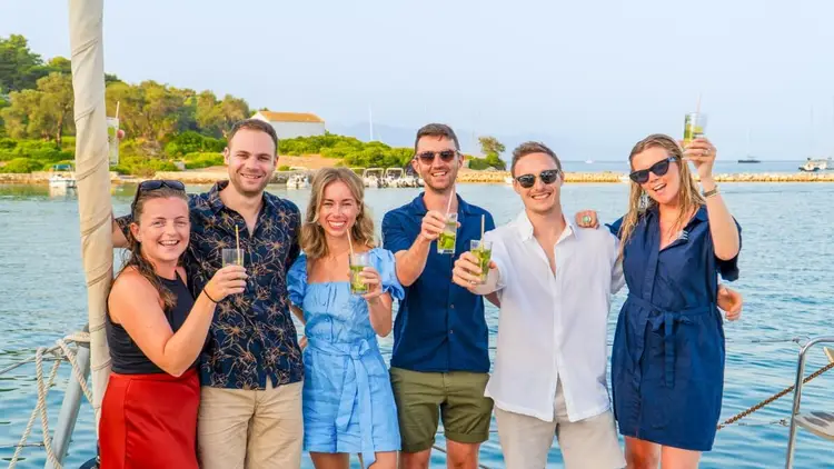 Couples enjoying drinks together aboard a yacht during a small-group sailing holiday in Croatia with Yacht Getaways.