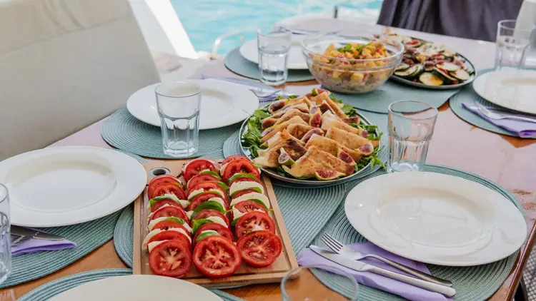 Food for lunch laid out on a table of a catamaran