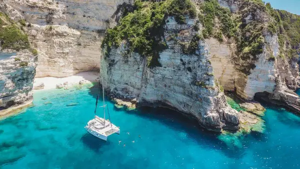 Catamaran anchored in a bay in Antipaxos