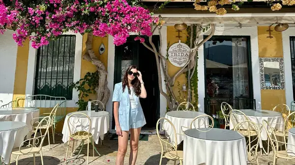 Woman standing in front of a restaurant in Kioni