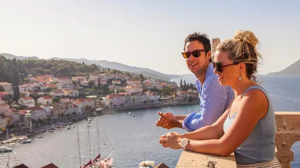 Couple look over Korcula from the top of a tower