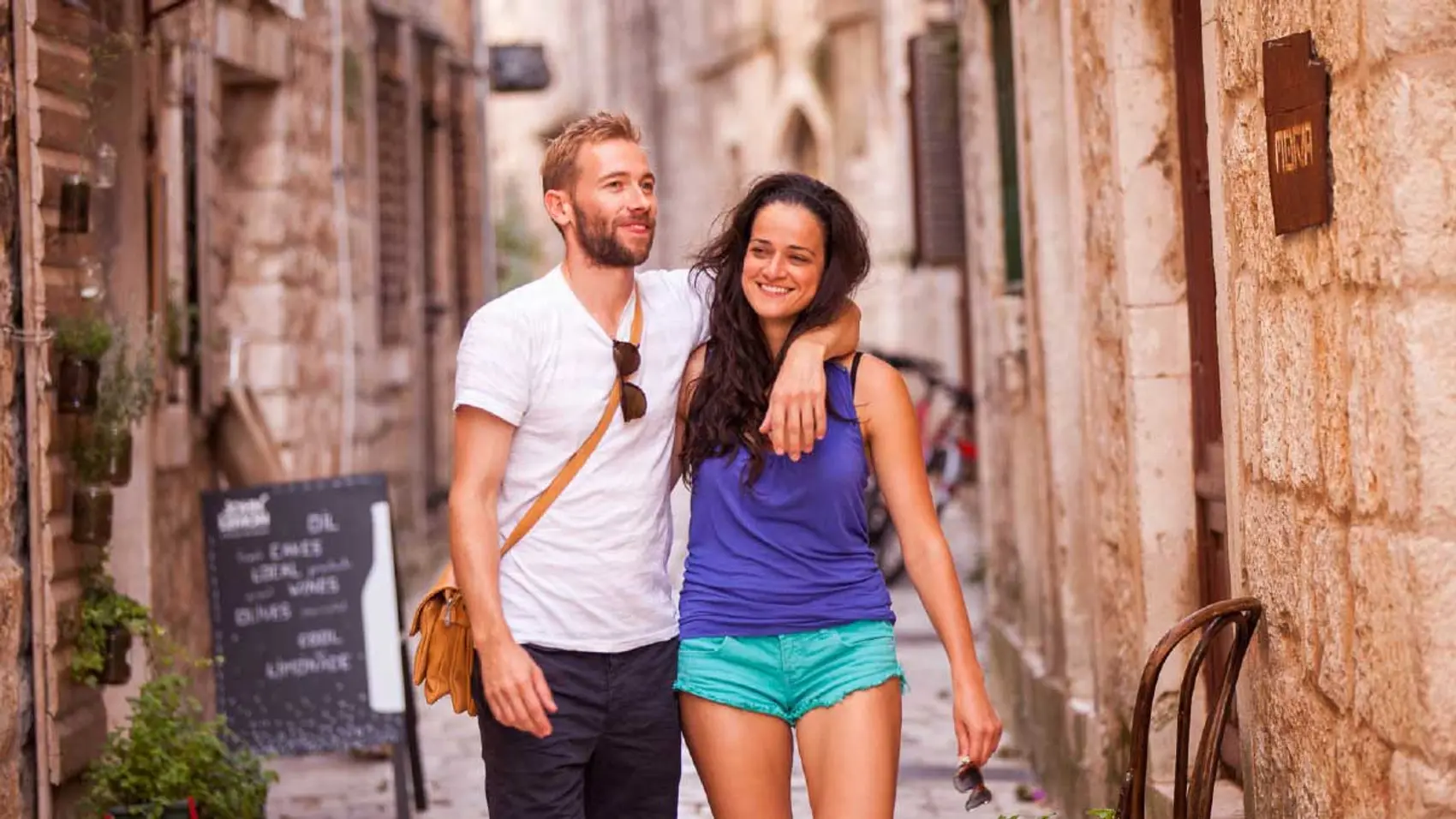 Couple walking the streets of Stari Grad in Croatia