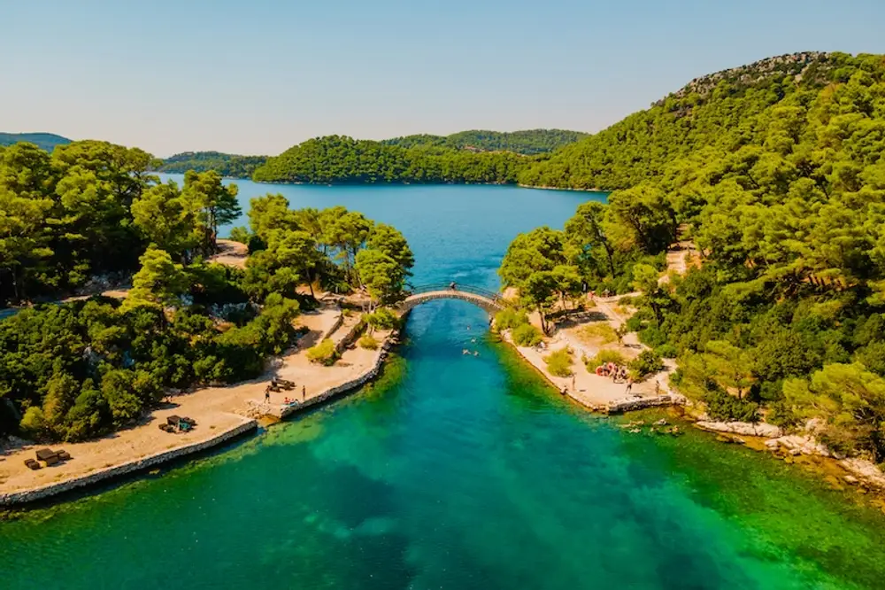 Aerial photo of Mljet National Park with turquoise lakes and bright green forest explored best on a luxury Croatia cycle cruise with yacht Getaways.