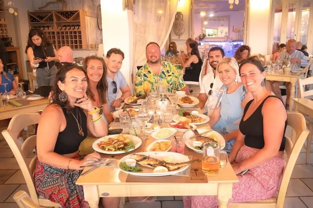 Group of people at a Greek restaurant while on a luxury catamaran cruise around Corfu.