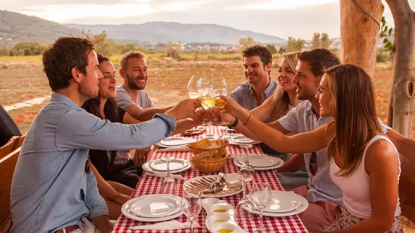 Group of people cheers their wine glasses