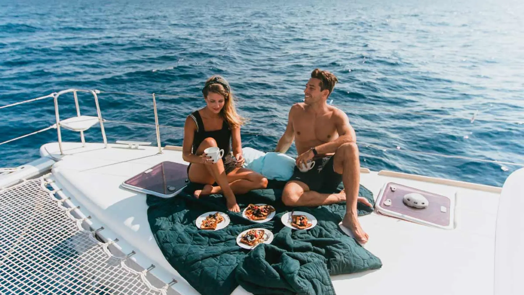 Couple enjoy lunch on Yacht Getaways catamaran