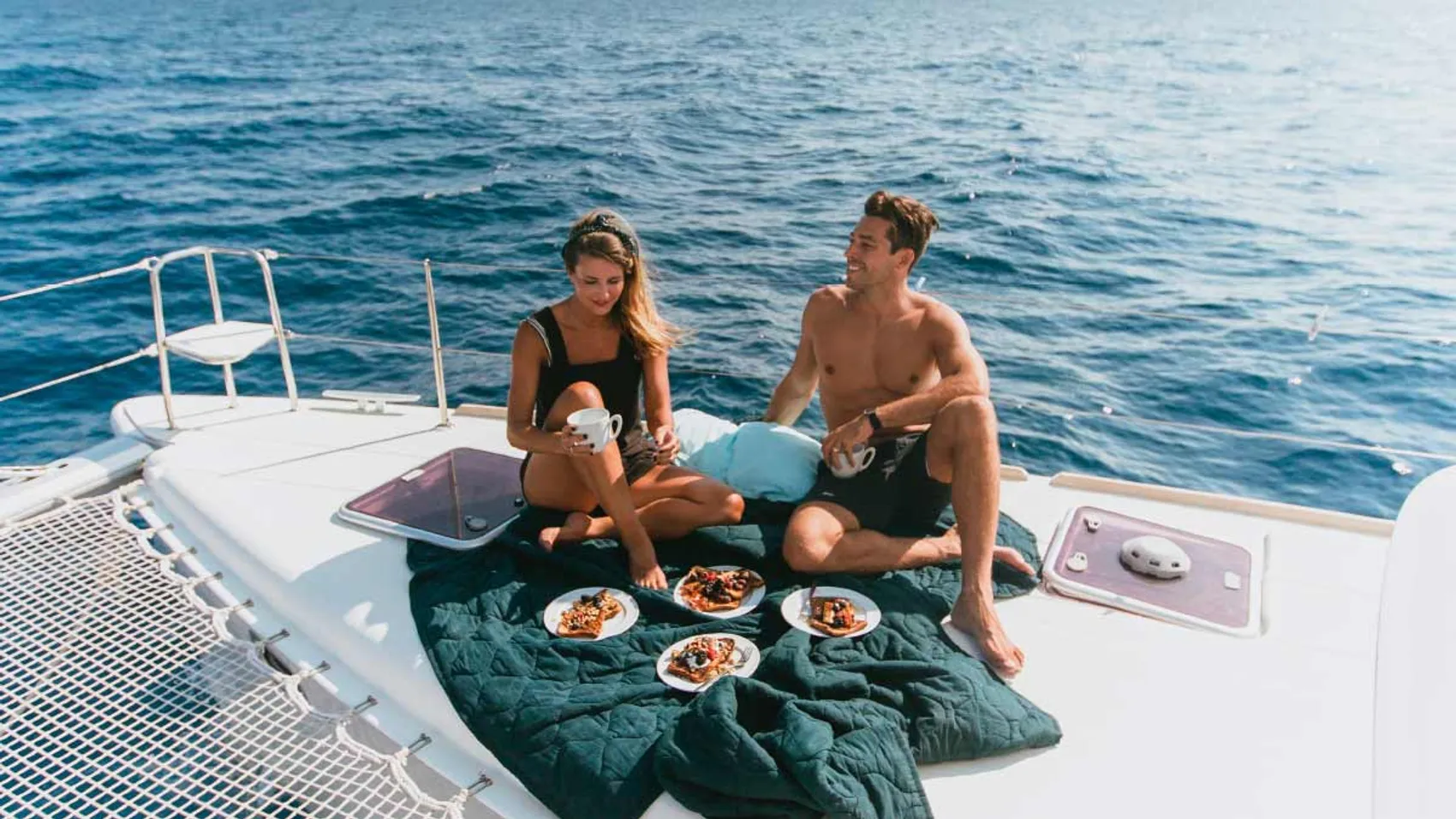 Couple enjoy lunch together on a Yacht Getaways catamaran