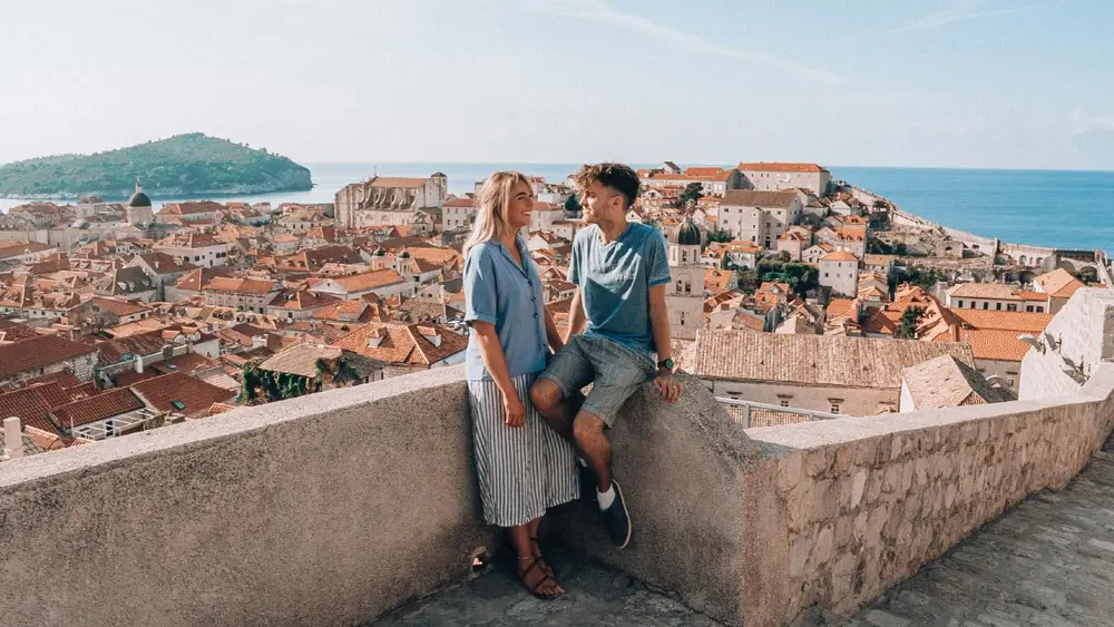 Couple sitting on the old town walls of Dubrovnik