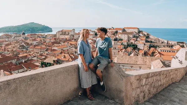 Couple sitting on the old town walls of Dubrovnik