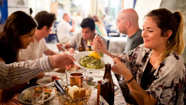 People enjoy a meal at a Greek restaurant