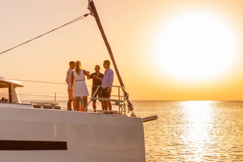 Group of people having sunset drinks on a yacht