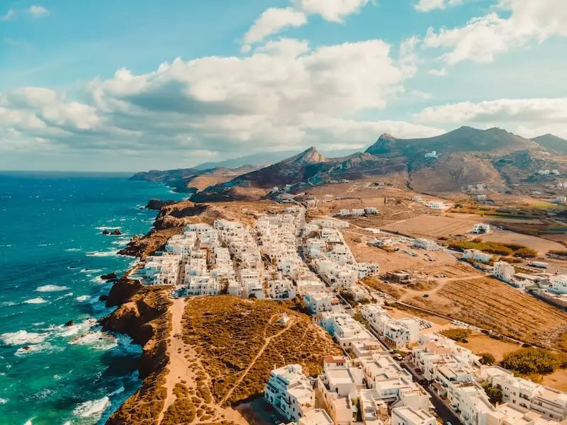 Naxos Island Greece aerial photo of white and blue villas on the coast.