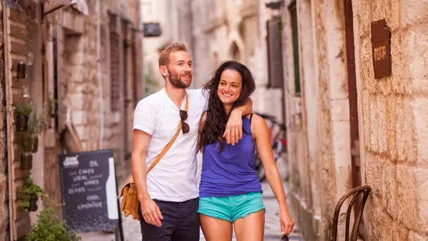 Couple walking the back streets of Trogir Old Town