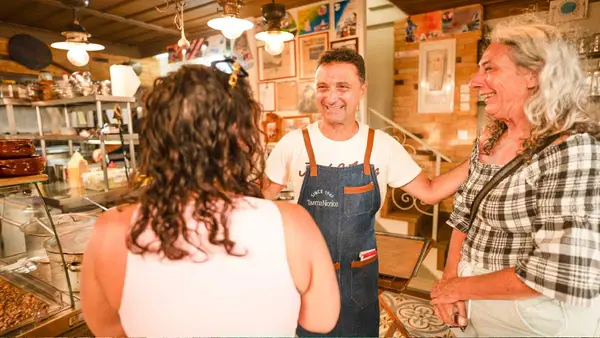 Restaurant owner greets some customers 