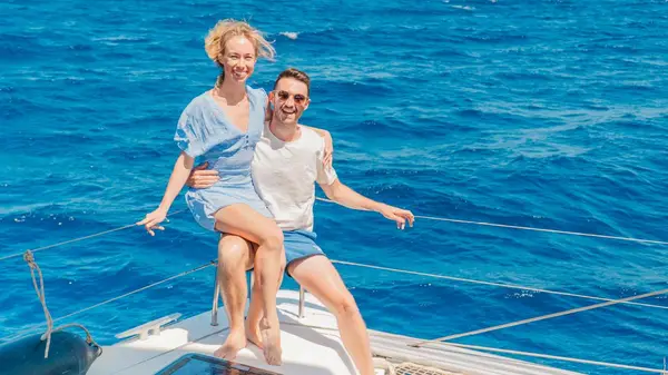 Couple pose for a photo on a yacht