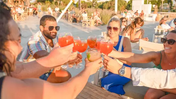 Group of people cheers their drinks