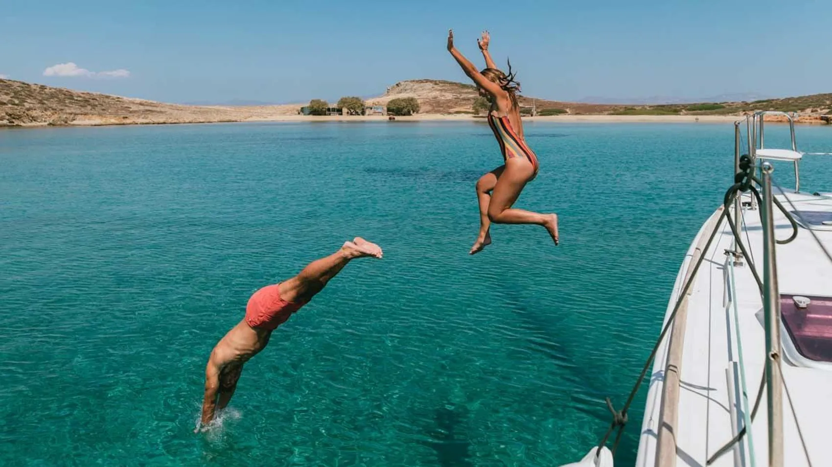 Yacht Getaways guests jump into water from yacht