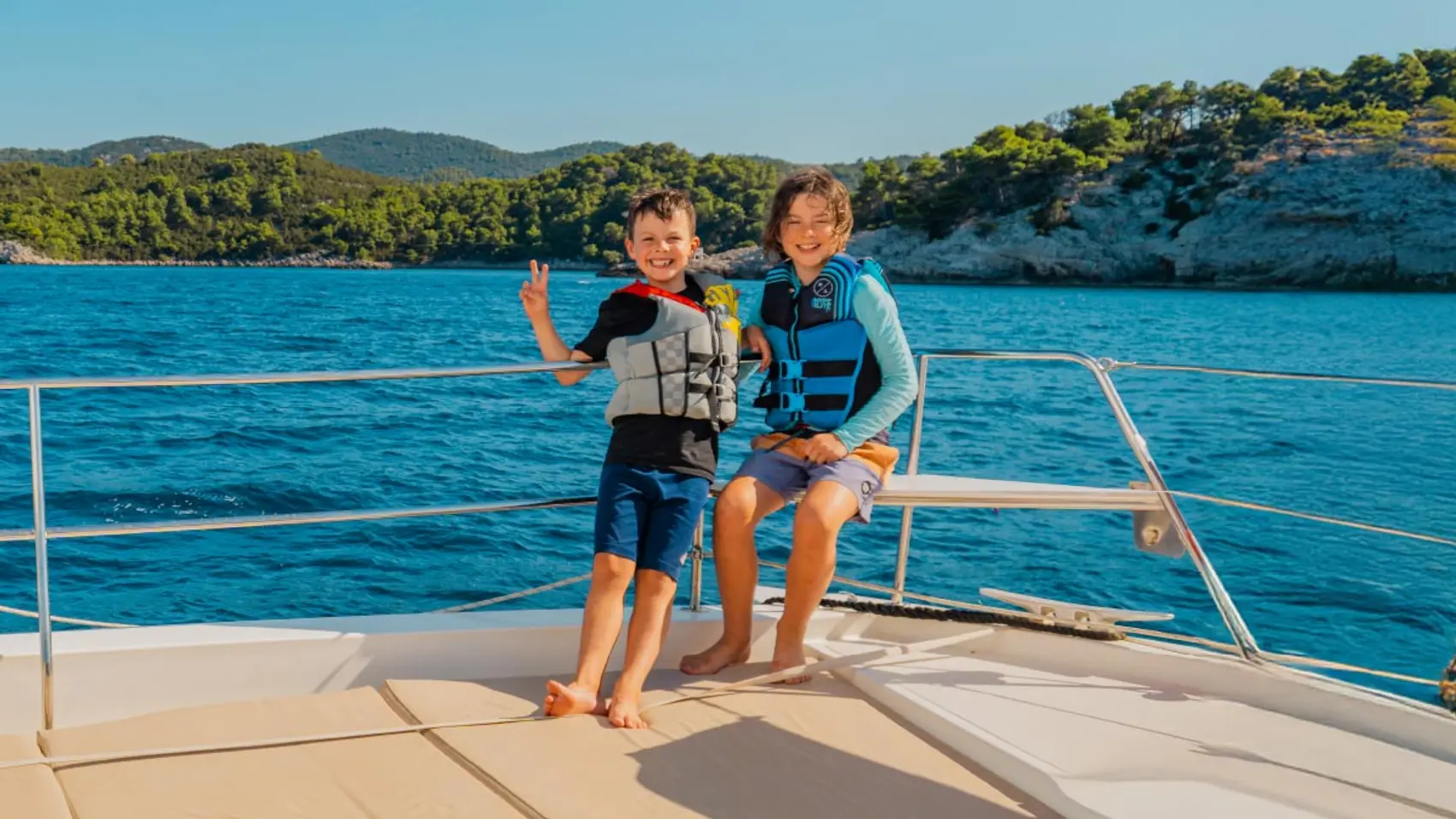 Two kids on a catamaran in Croatia