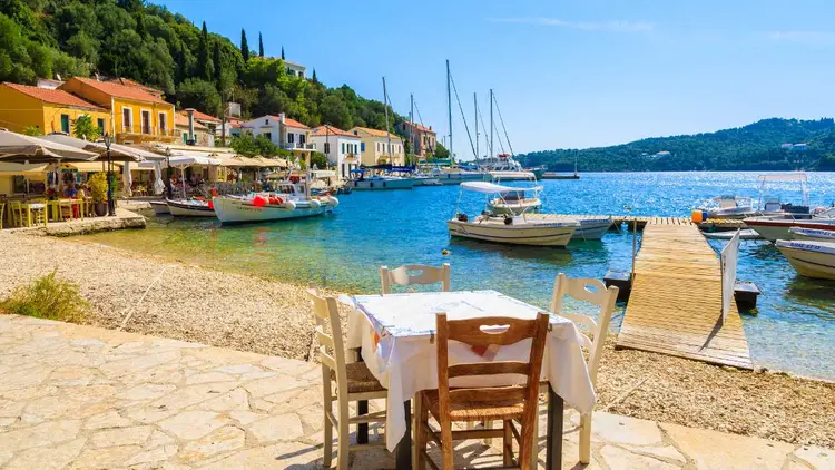 Restaurant table set up on the waterfront in Kioni