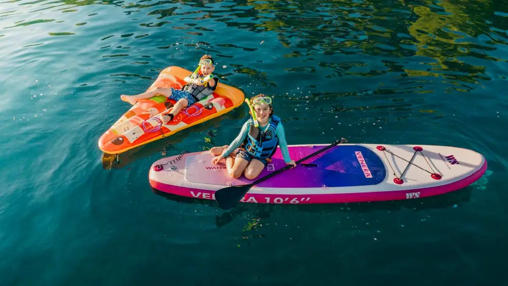 Two kids on paddle boards 