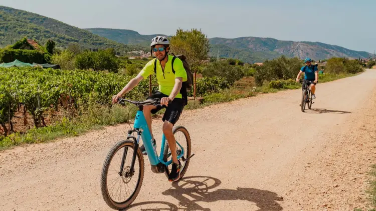 Cycling guide riding along a road in Croatia