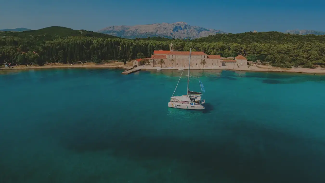 A Yacht Getaways luxury catamaran at anchor near Korcula island in Croatia.