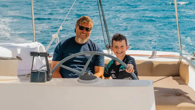 kid learning to sail on a  catamaran cruise