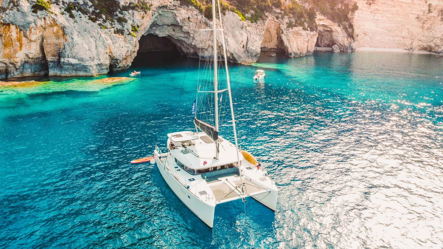 Yacht Getaways catamaran anchored in a bay with clear blue water