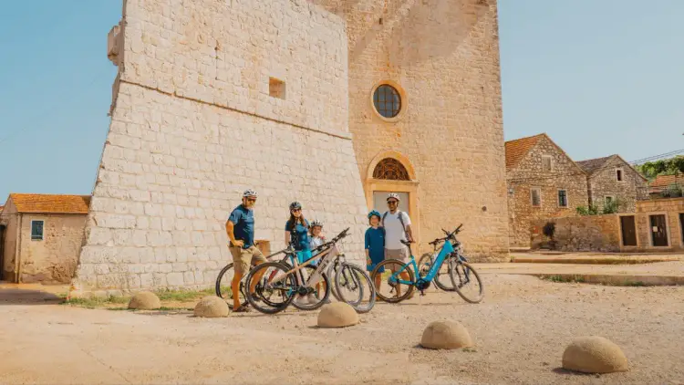 A family on bicycles explores historic Croatian towns and a fortified Venetian monastery in Vrboska while on a family sailing holiday around Croatia,