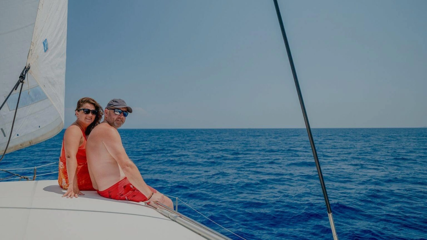 Couple relaxing together aboard a sailing yacht during a Mediterranean sailing holiday with Yacht Getaways.