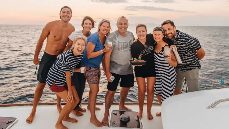 Group of people celebrate a birthday onboard a Yacht Getaways catamaran