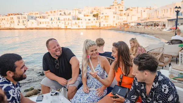 Group of friends having a sunset drink in Naoussa