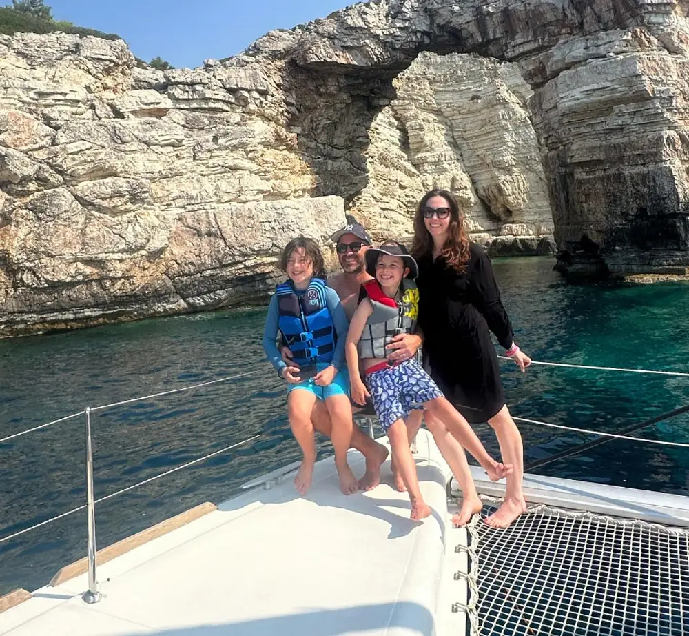 Family on a catamaran in Greece