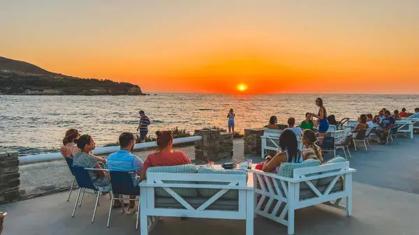 Group of people enjoying sunset drinks in Paros