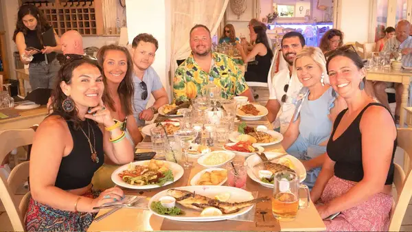 Group of people pose for a photo at a Greek restaurant