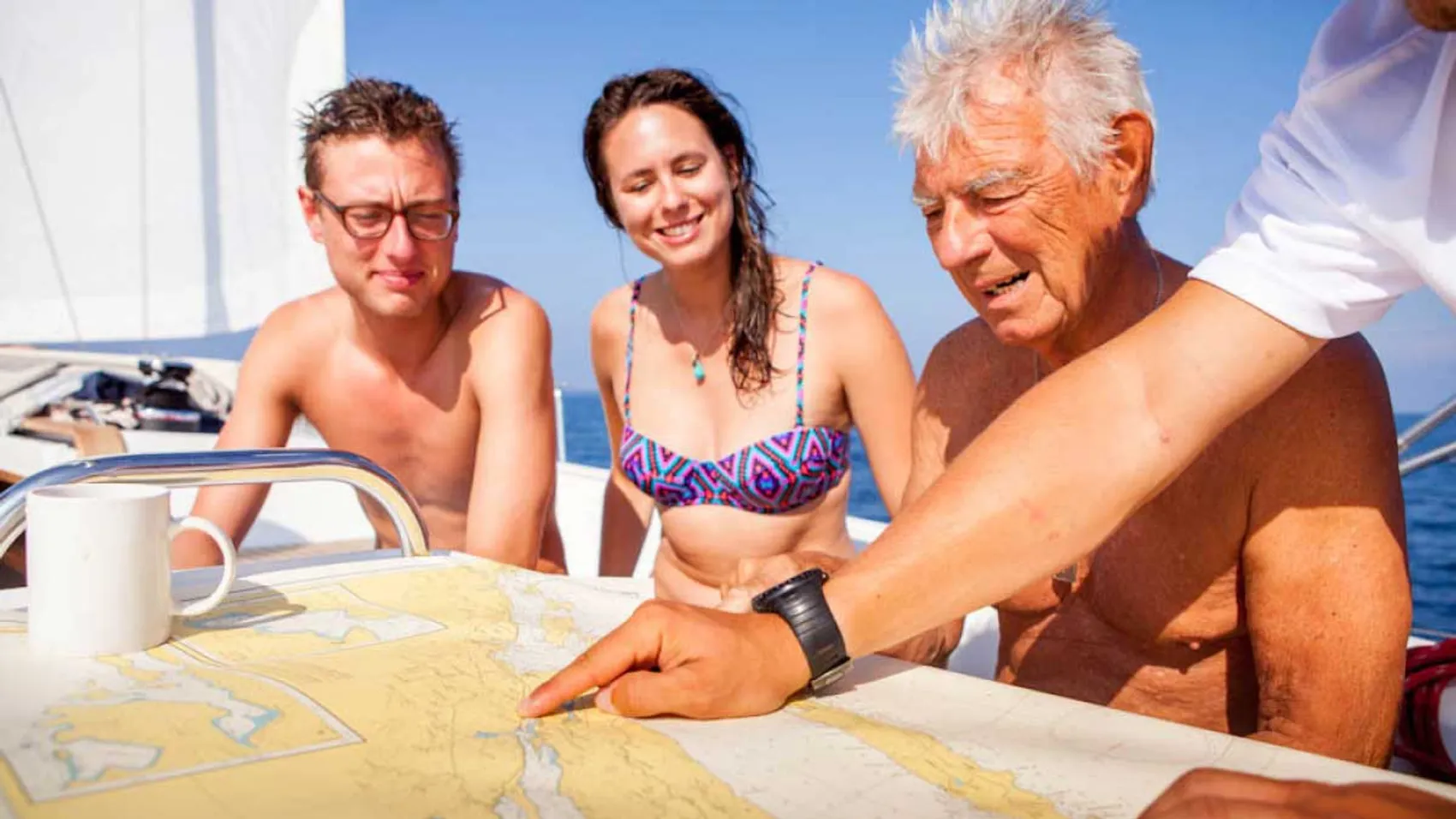 Family being shown the sailing route by their skipper