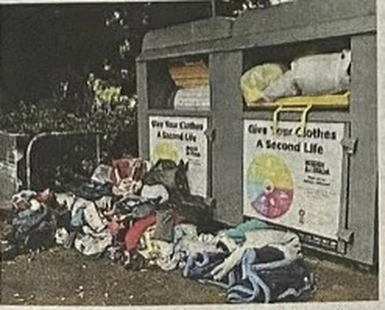 Clothing and household goods dumped beside overflowing charity donation bins