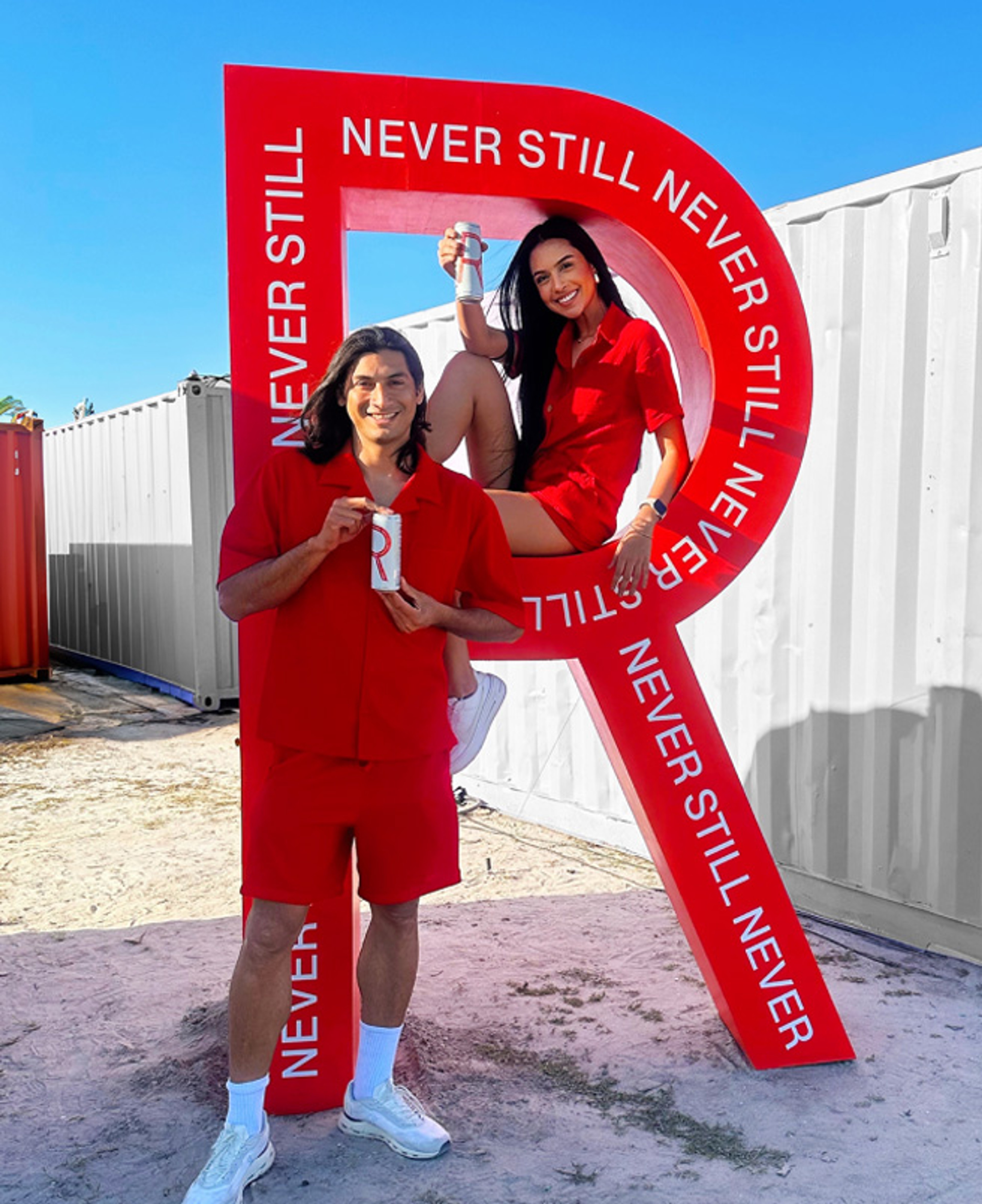 Giant red R sculpture wrapped in Never Still lettering, used as a festival photo op